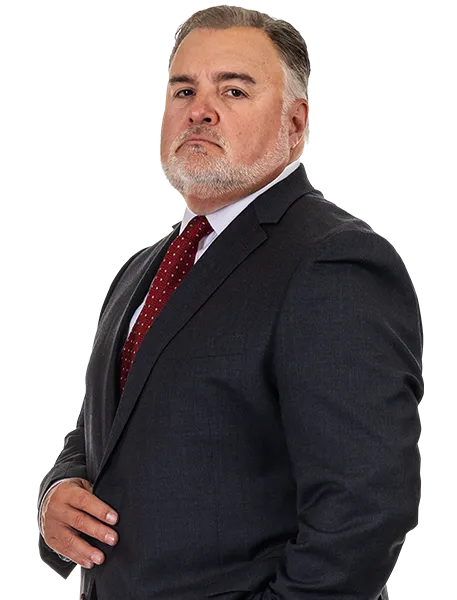Personal Injury Attorney Joel Hamner Wearing A Charcoal Suit With Red Tie Cropped Above The Hip