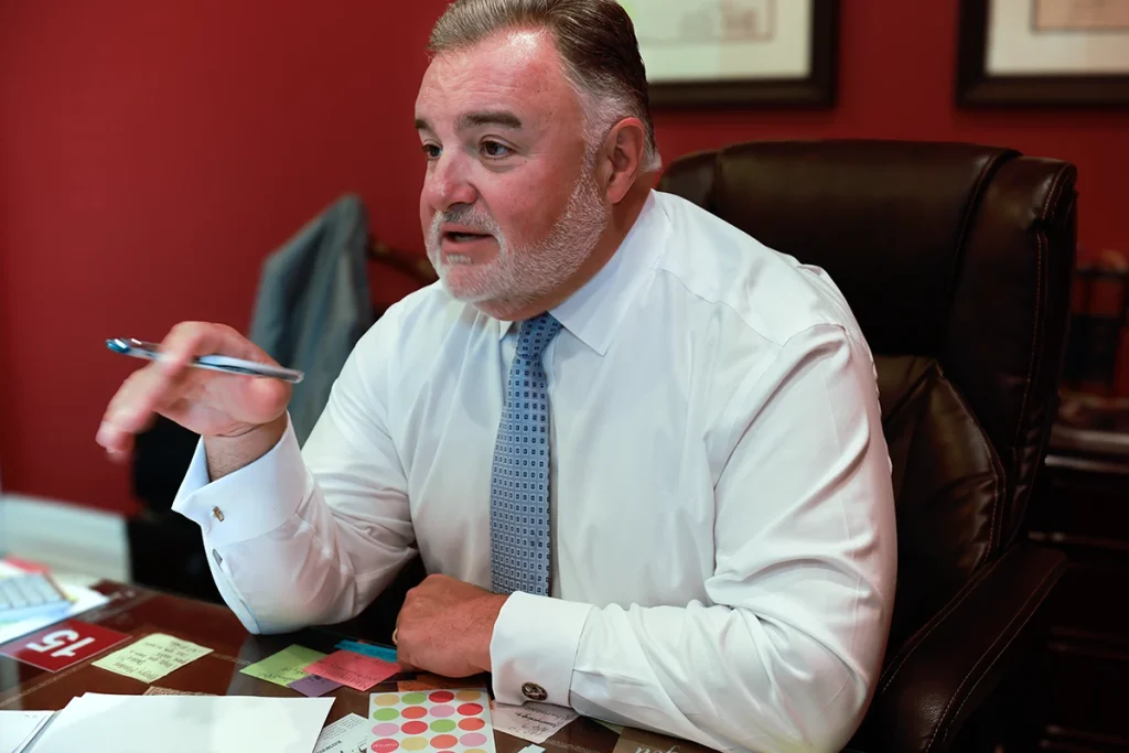 Attorney joel hamner discusses a brake failure exhibit with a client, highlighting mechanical inspection data.