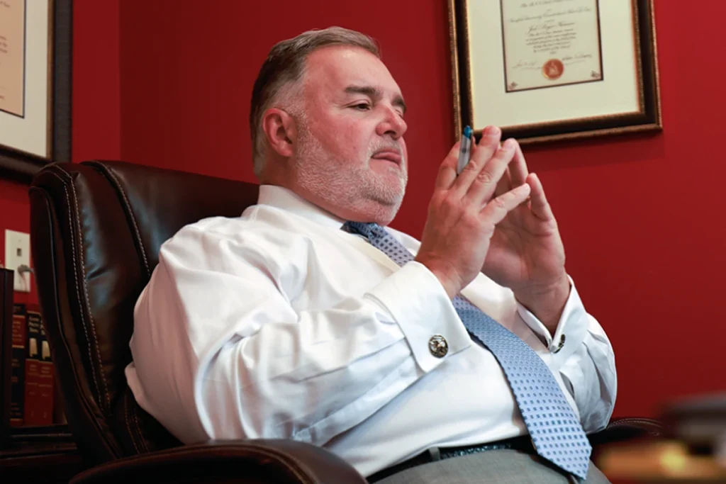 Attorney joel hamner discusses a homeowner liability exhibit with a client, highlighting property defects.