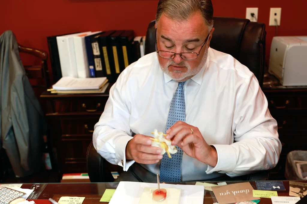 Attorney joel hamner discusses a neck injuries with a client.