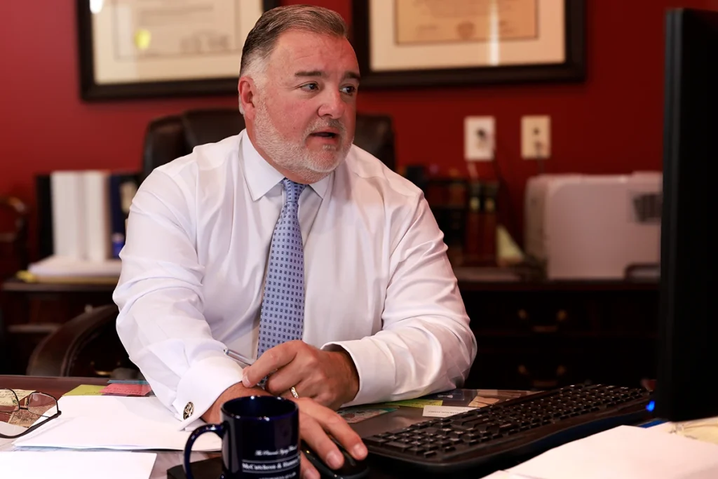 Attorney joel hamner discusses a wrongful death exhibit with a client, focusing on key trial evidence.