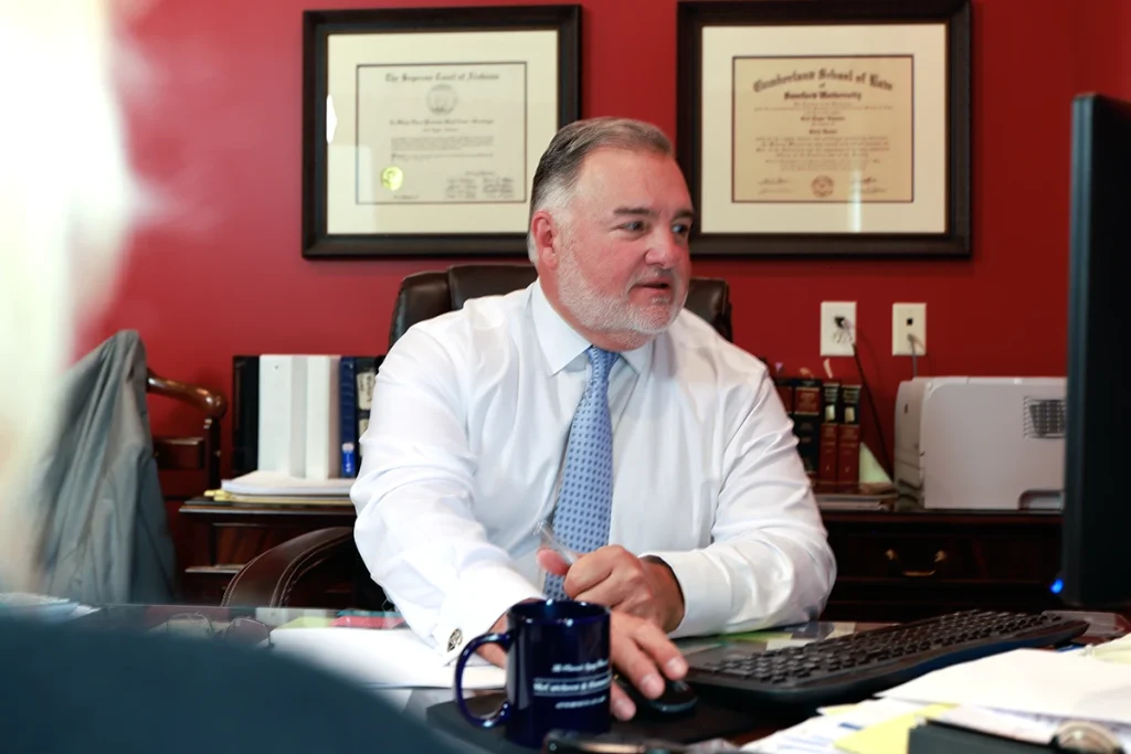 Attorney joel hamner explains a vision loss exhibit to a client, featuring ophthalmology records.