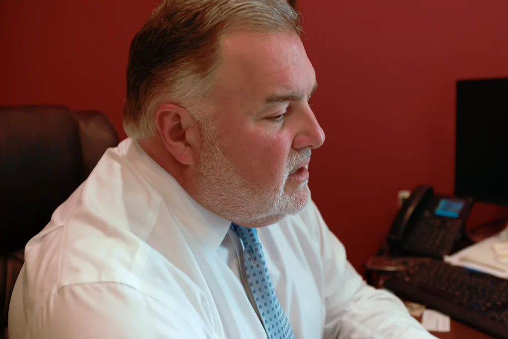 Attorney joel hamner meets with a client to discuss a lyft accident exhibit highlighting driver logs.