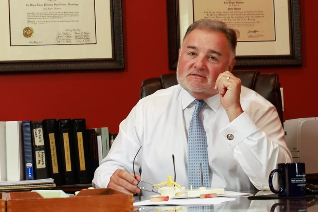 Attorney joel hamner meets with a client to review a pizza delivery accident exhibit including route maps.