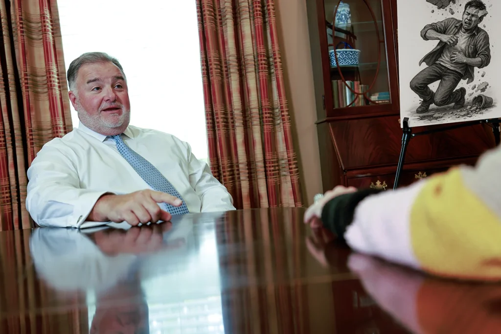 Attorney joel hamner presents a landlord liability exhibit to a client, showing unsafe property conditions.