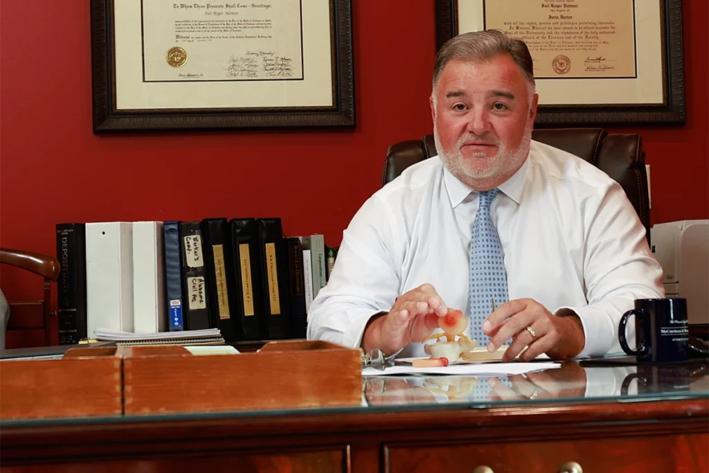 Attorney joel hamner presents a recreational vehicle accident exhibit to a client, showing campsite evidence.