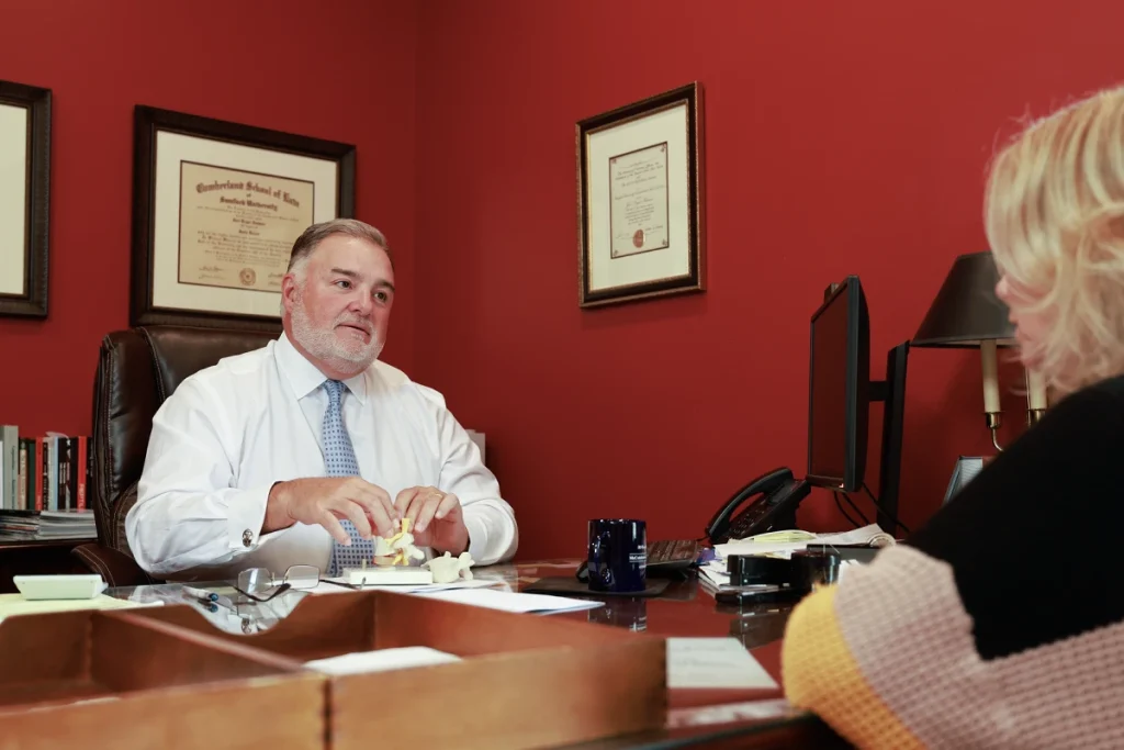 Attorney joel hamner presents a truck accident exhibit to a client, showing black box data.