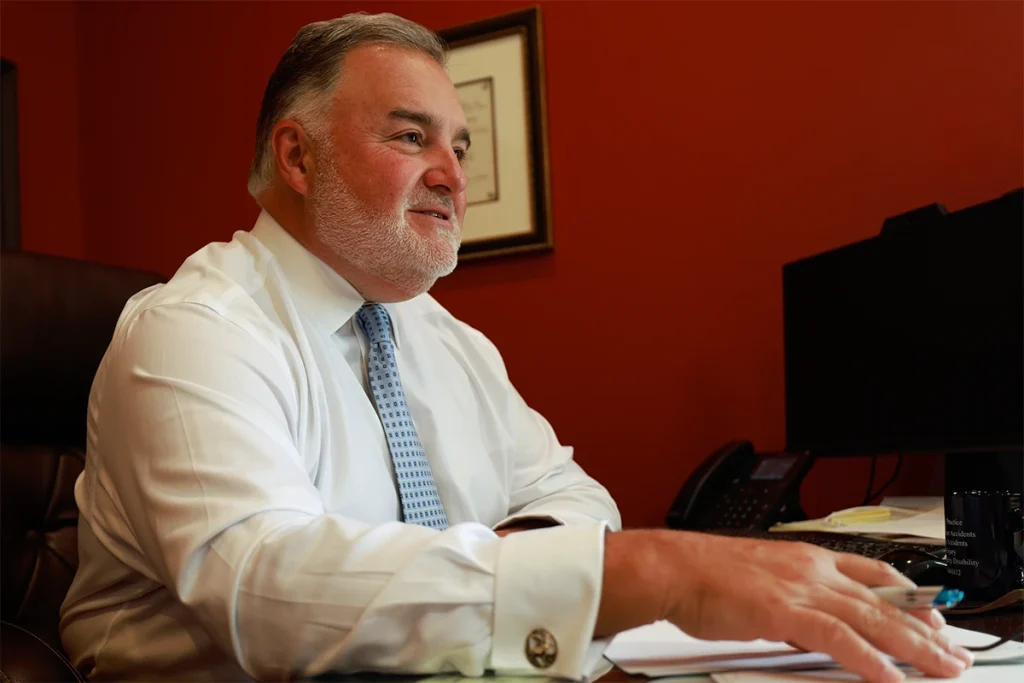 Attorney joel hamner reviews a concussion and tbi exhibit with a client, pointing out medical imaging.