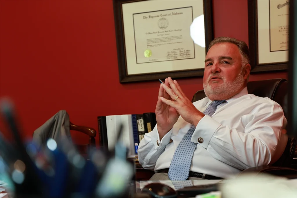 Attorney joel hamner reviews a food poisoning exhibit with a client, noting lab results.
