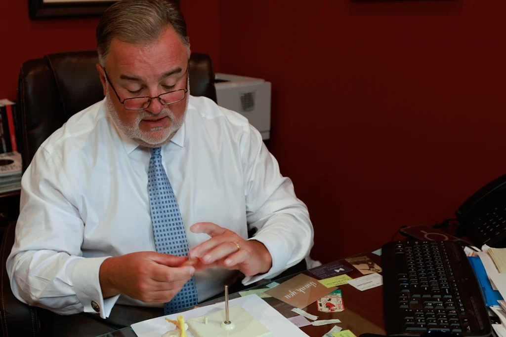 Attorney joel hamner reviews a nerve injury exhibit with a client, noting neurological test results.