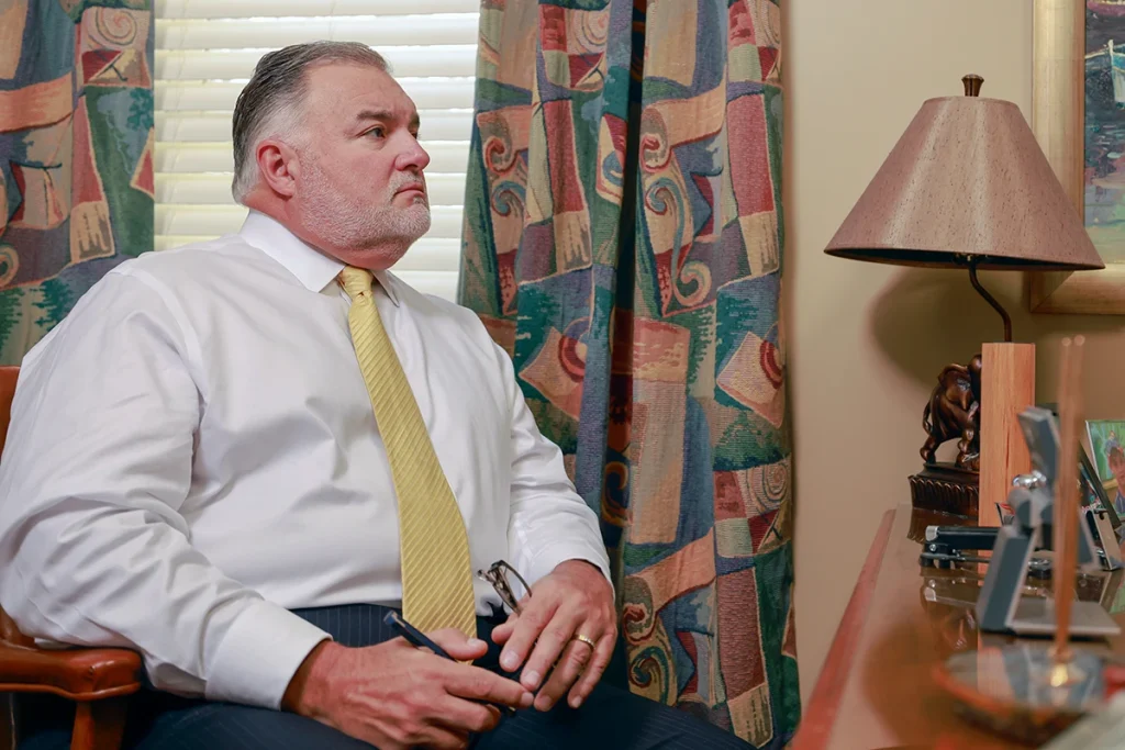 Attorneys joel hamner and tom mccutcheon consult with a client about a distracted driving accident claim.