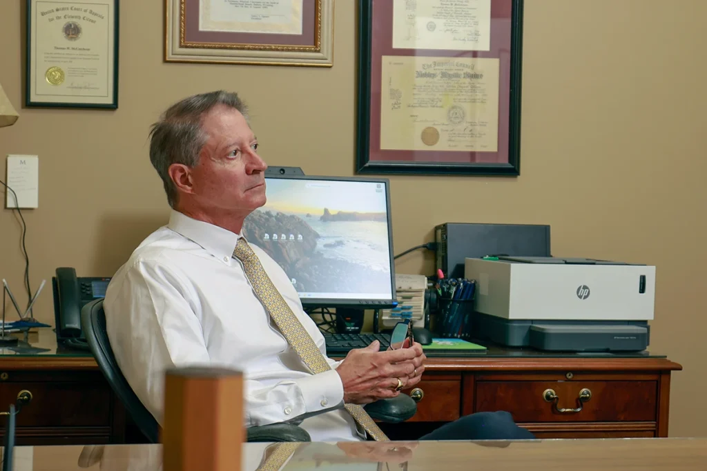 Attorneys joel hamner and tom mccutcheon consult with a client about a taxi accident lawsuit.