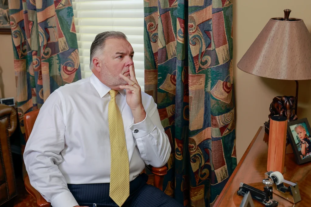 Attorneys joel hamner and tom mccutcheon talk with a client about a fedex delivery accident claim.