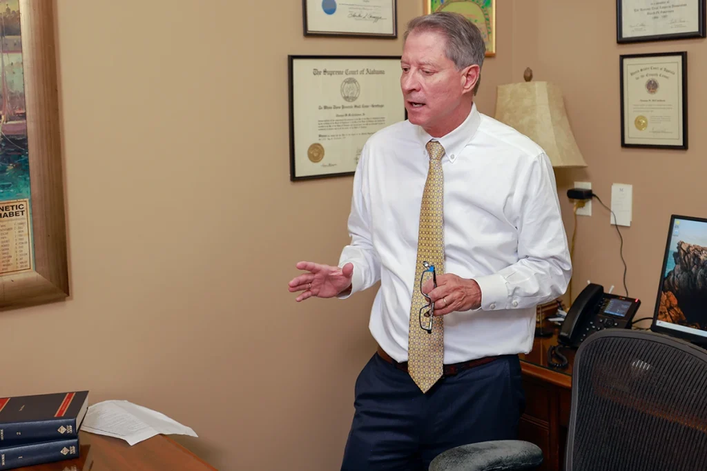 Attorneys joel hamner and tom mccutcheon talk with a client about a drowning accident case.