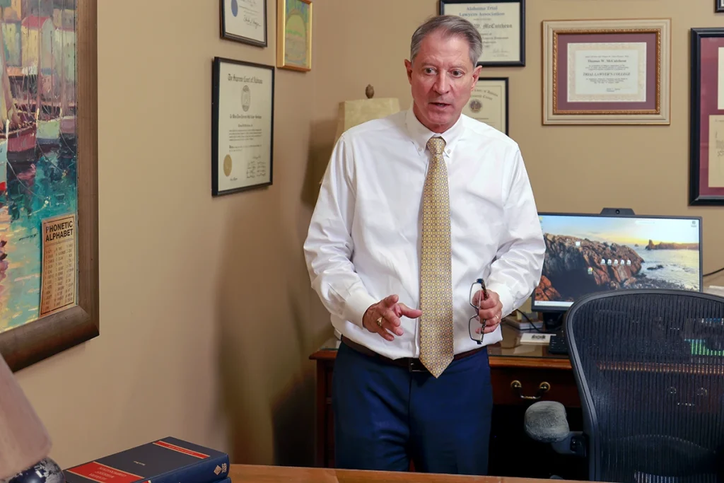 Attorneys joel hamner and tom mccutcheon talk with a client about a head on collision claim.