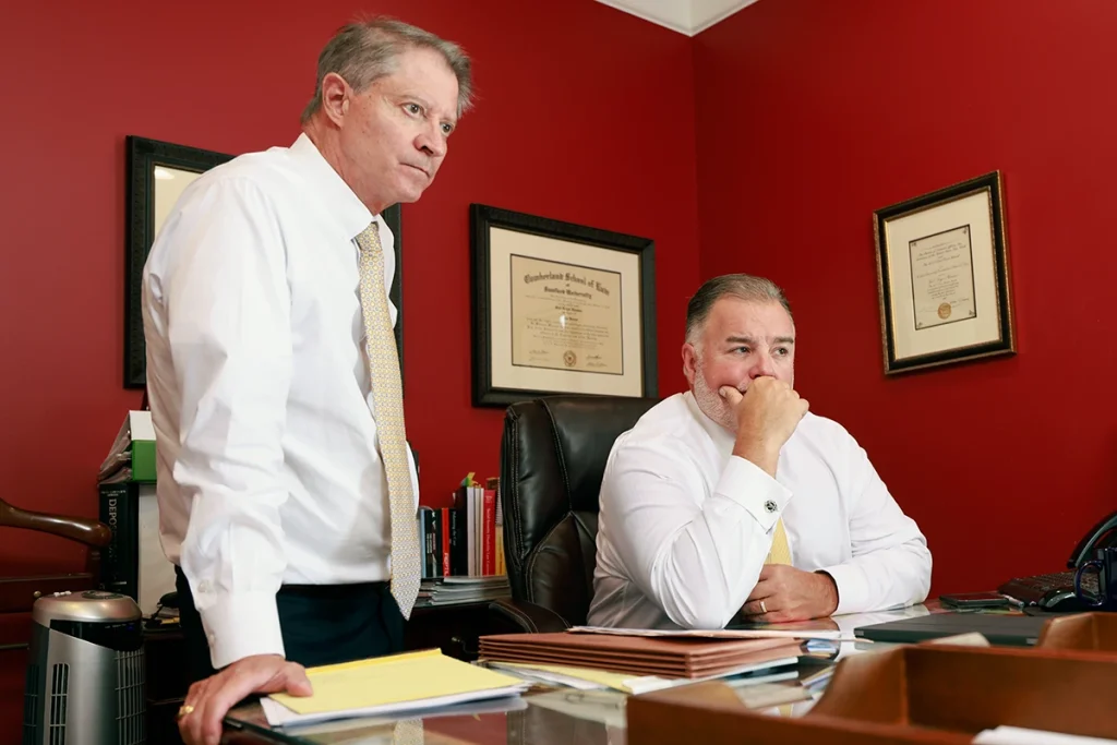 Attorneys tom mccutcheon and joel hamner meet with a client to discuss a complex nerve injury claim.