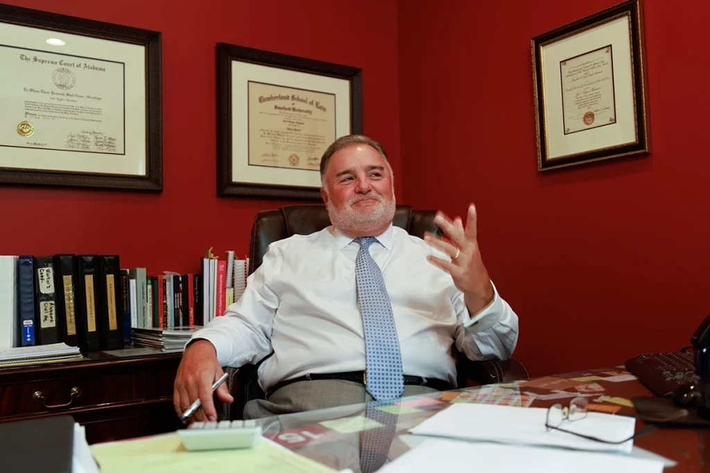 Lawyer joel hamner discusses a fedex accident exhibit with a client, including delivery route evidence.