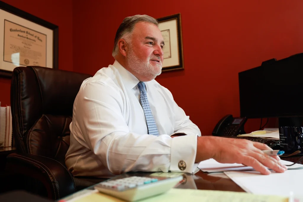 Lawyer joel hamner discusses a catastrophic injury exhibit with a client, highlighting long term care needs.