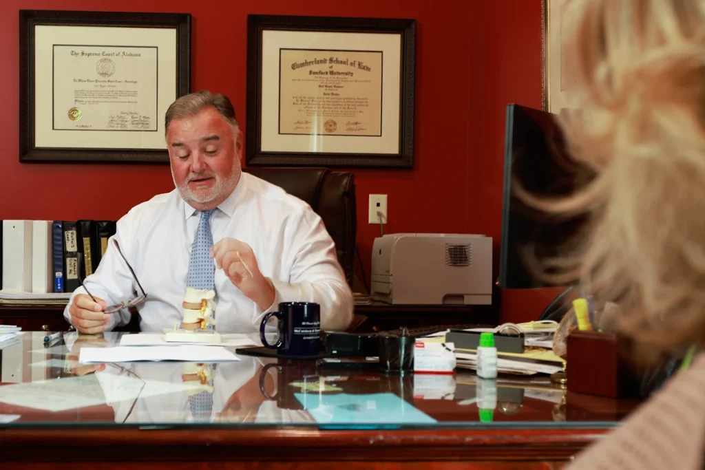 Lawyer joel hamner discusses a side swipe accident exhibit with a client, covering lane change analysis.