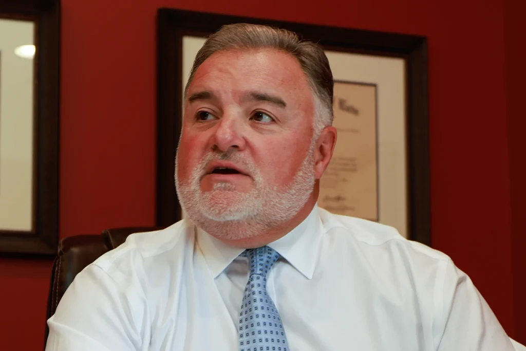 Lawyer joel hamner discusses an insurance litigation exhibit with a client, outlining coverage disputes.