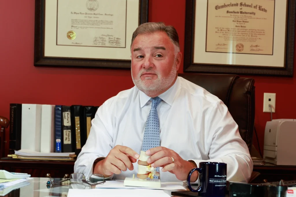 Lawyer joel hamner explains a speeding accident exhibit to a client, noting radar gun readings.