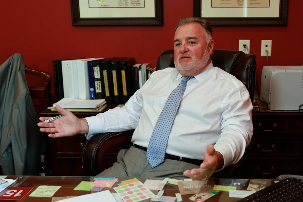 Lawyer joel hamner meets with a client to review a doordash accident exhibit featuring delivery logs.