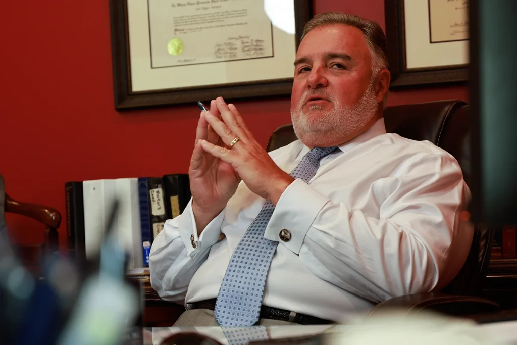 Lawyer joel hamner meets with a client to review a postmates accident exhibit including delivery logs.
