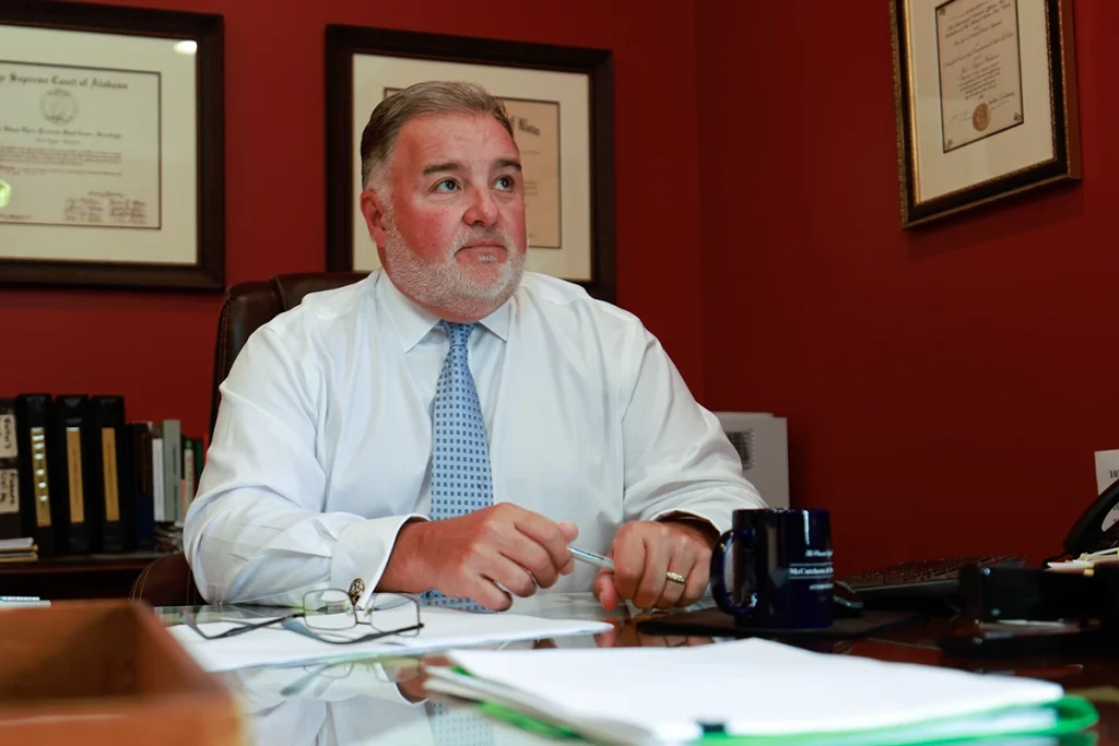 Lawyer joel hamner meets with a client to review a falling object accident exhibit detailing workplace safety lapses.
