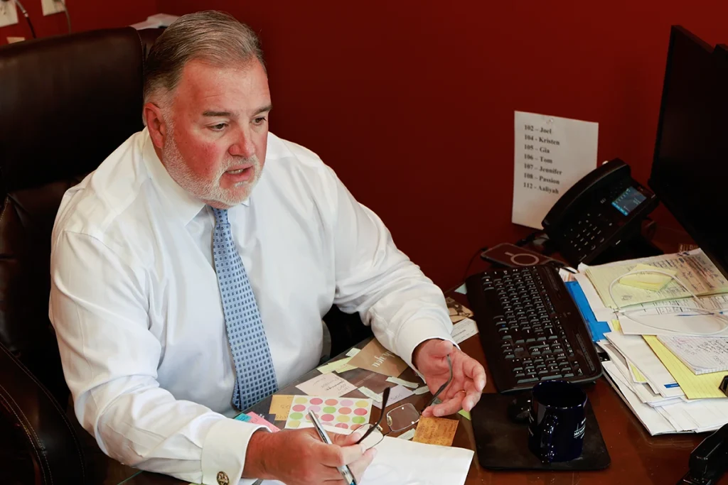 Lawyer joel hamner meets with a client to review a jogger accident exhibit featuring driver visibility data.
