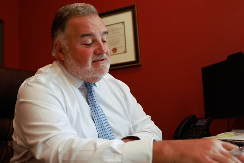 Lawyer joel hamner meets with a client to review an organ damage injury exhibit with medical imaging evidence.