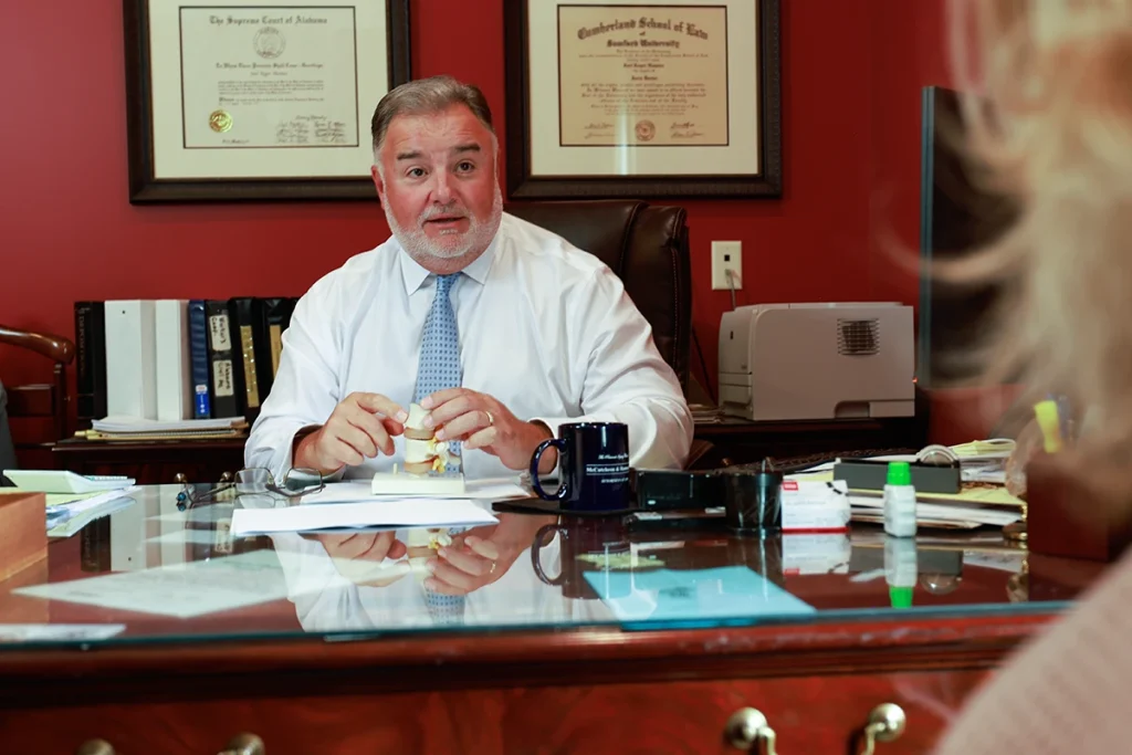 Lawyer joel hamner presents a day care accident exhibit to a client, highlighting childcare safety concerns.