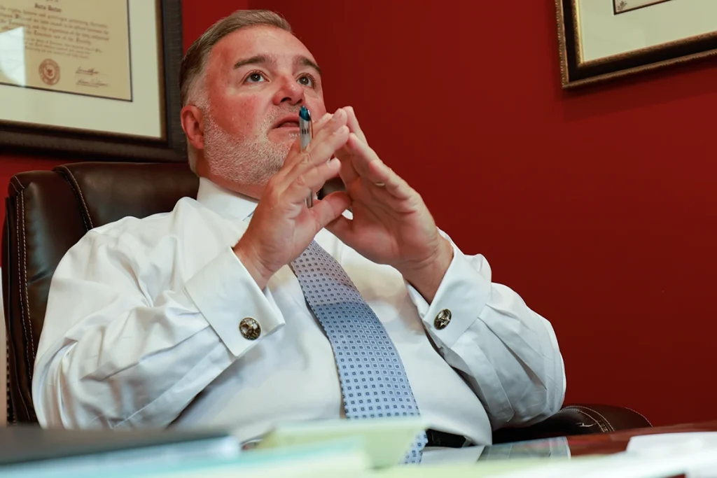 Lawyer joel hamner reviews a public transportation accident exhibit with a client, noting passenger statements.