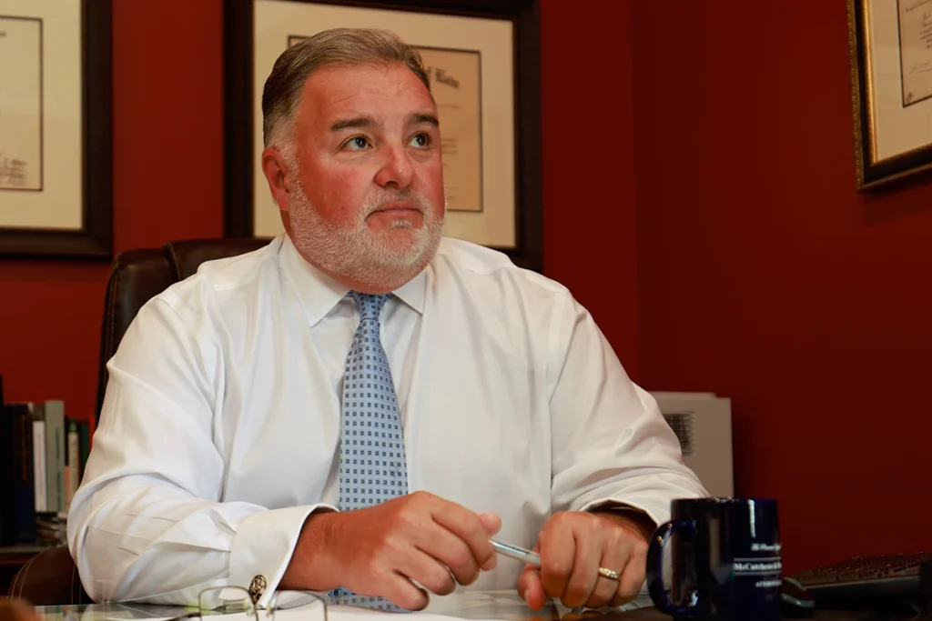 Lawyer joel hamner reviews an insurance bad faith exhibit with a client, detailing claim denial evidence.