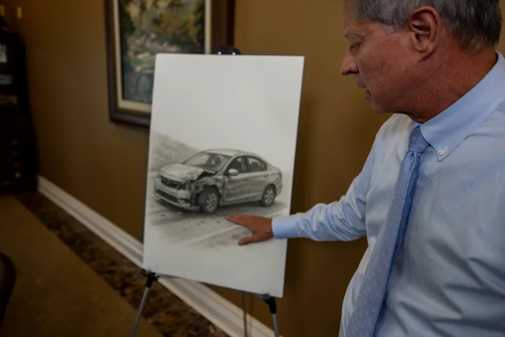 Lawyer tom mccutcheon examines a hit and run exhibit with traffic camera stills and witness statements.