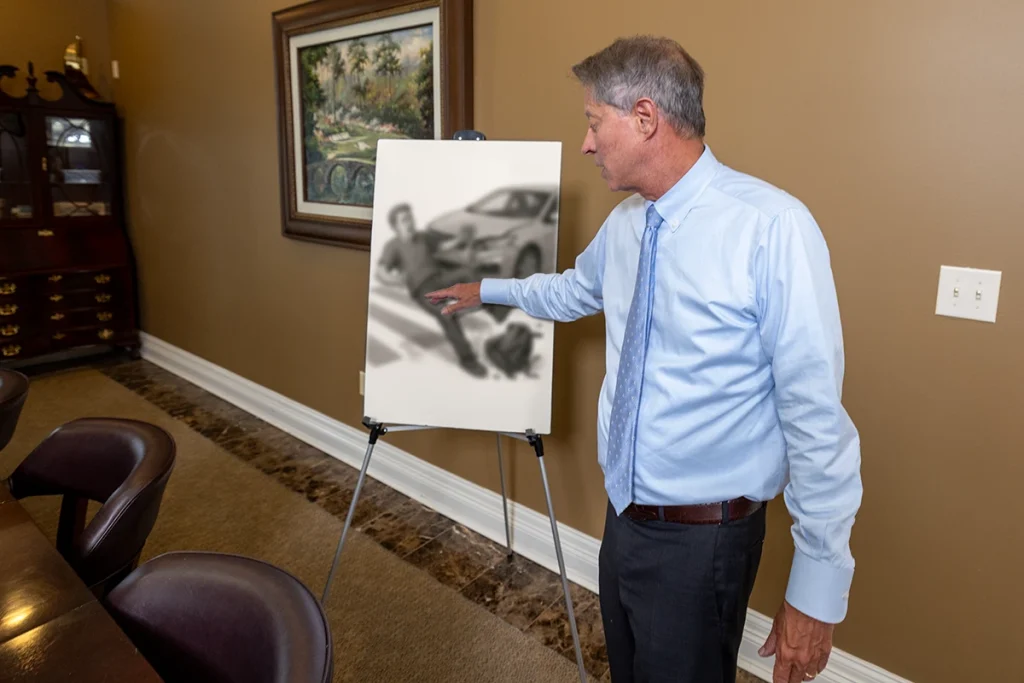 Lawyer tom mccutcheon examines a pedestrian accident exhibit that maps crosswalk signals and driver speed.