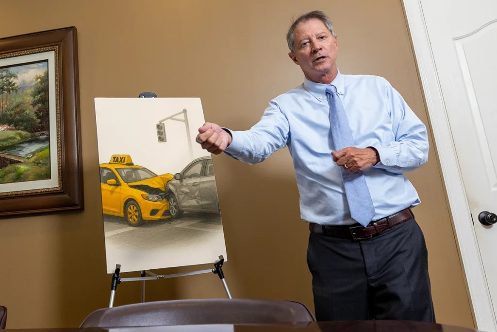Lawyer tom mccutcheon explains a taxi accident exhibit with driver logs and witness accounts.