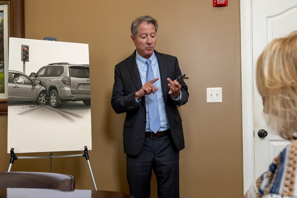 Personal injury attorney tom mccutcheon consults with a client about a distracted driving accident claim.