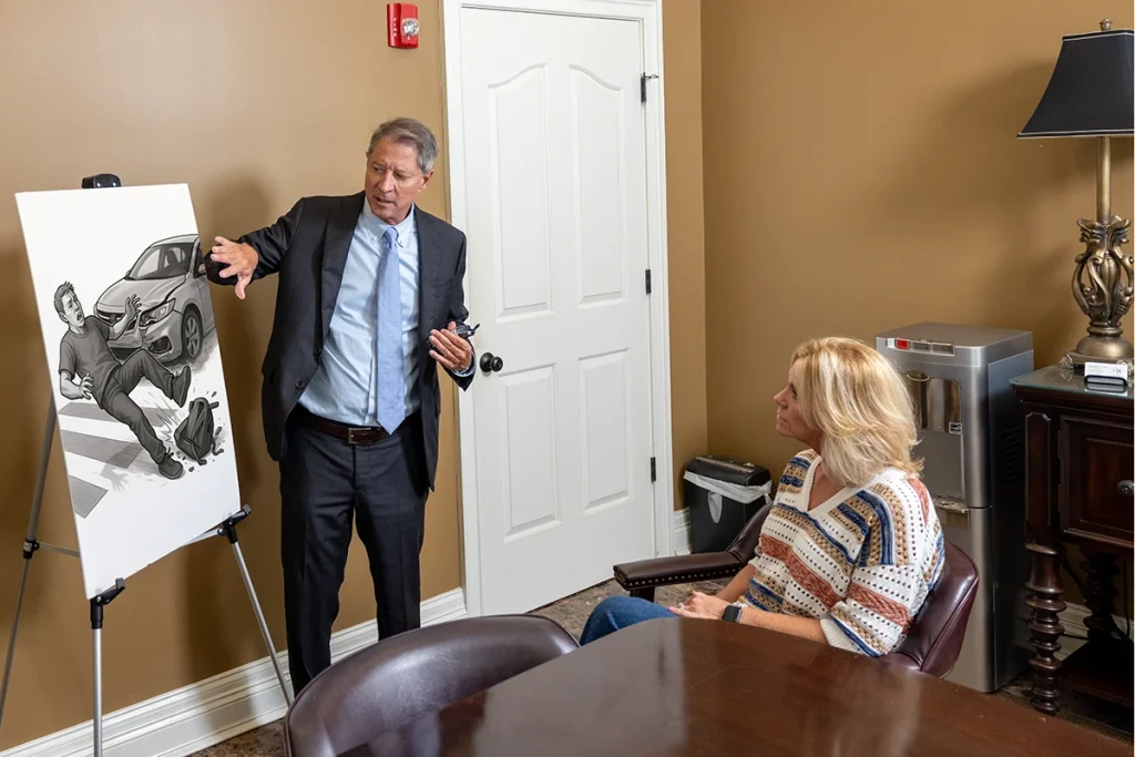 Personal injury attorney tom mccutcheon discusses a pedestrian accident case with a client.