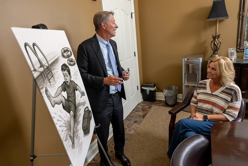Personal injury attorney tom mccutcheon discusses a swimming pool accident case with a client.