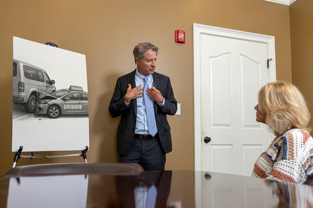 Personal injury attorney tom mccutcheon meets with a client to review a grubhub accident case.
