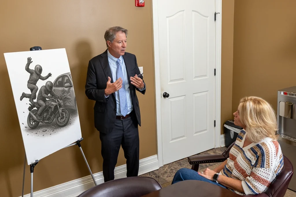 Personal injury attorney tom mccutcheon talks with a client about a motorcycle passenger injury case.