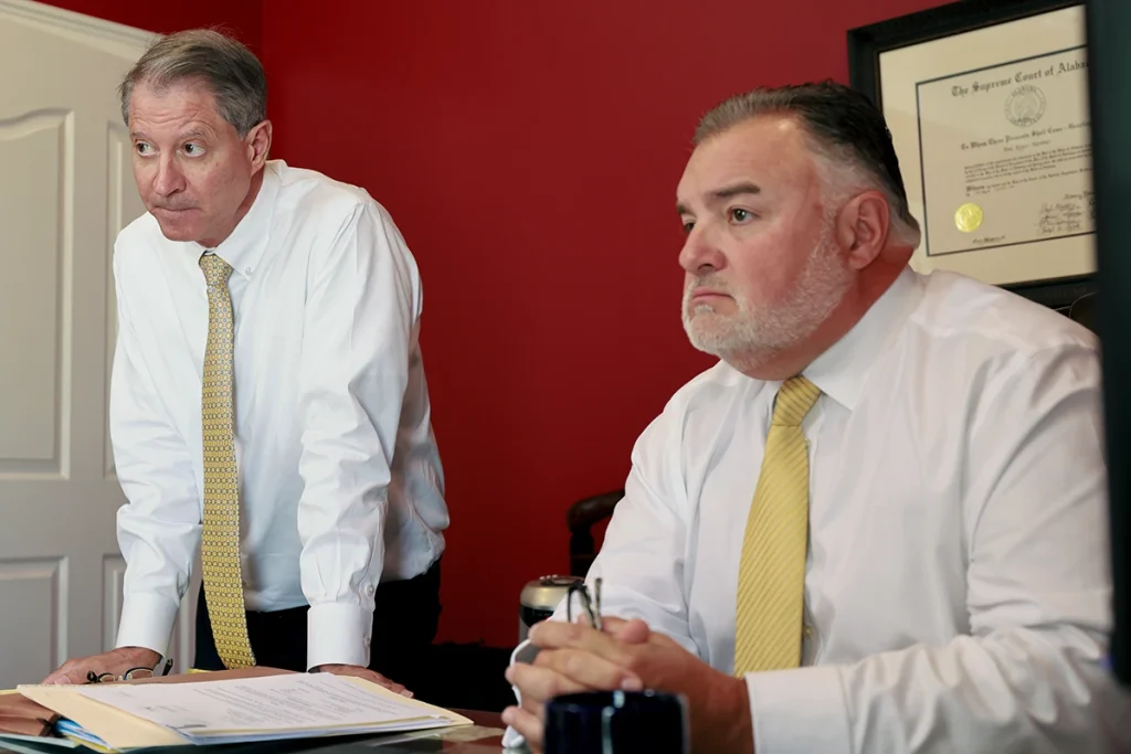 Tom mccutcheon and joel hamner meet with a client to discuss a recreational vehicle accident lawsuit.