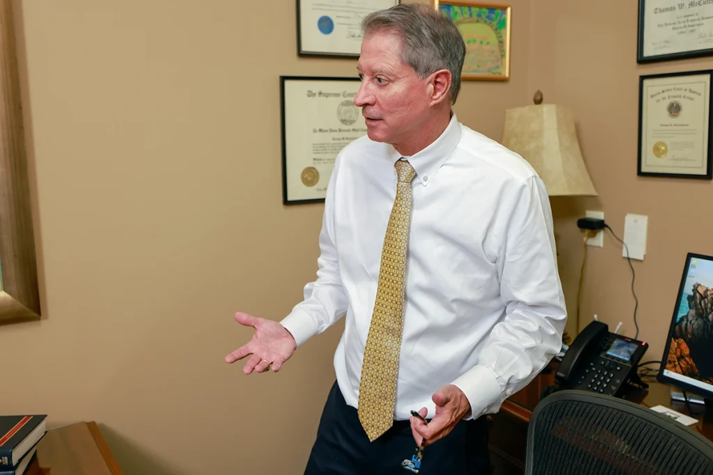 Tom mccutcheon and joel hamner meet with a client to review a farm accident lawsuit.