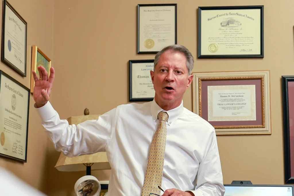 Tom mccutcheon and joel hamner meet with a client to review a helicopter accident lawsuit.