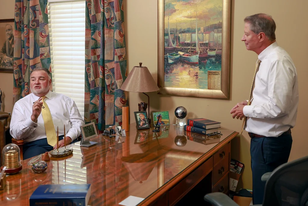 Tom mccutcheon and joel hamner meet with a client to review a runaway vehicle accident claim.