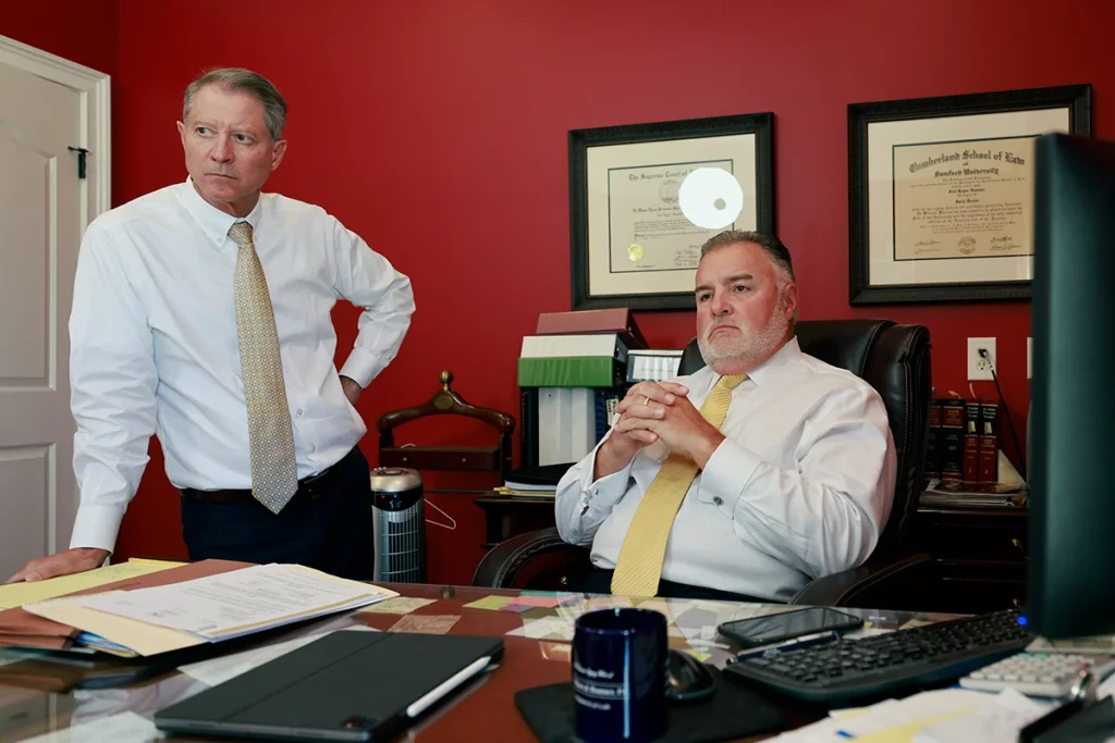 Tom mccutcheon and joel hamner review medical imaging with a client considering a spinal cord injury lawsuit.