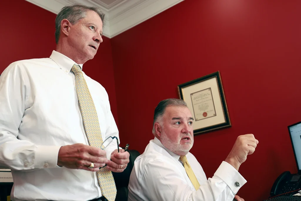 Tom mccutcheon and joel hamner review records with a client exploring an emotional distress lawsuit.