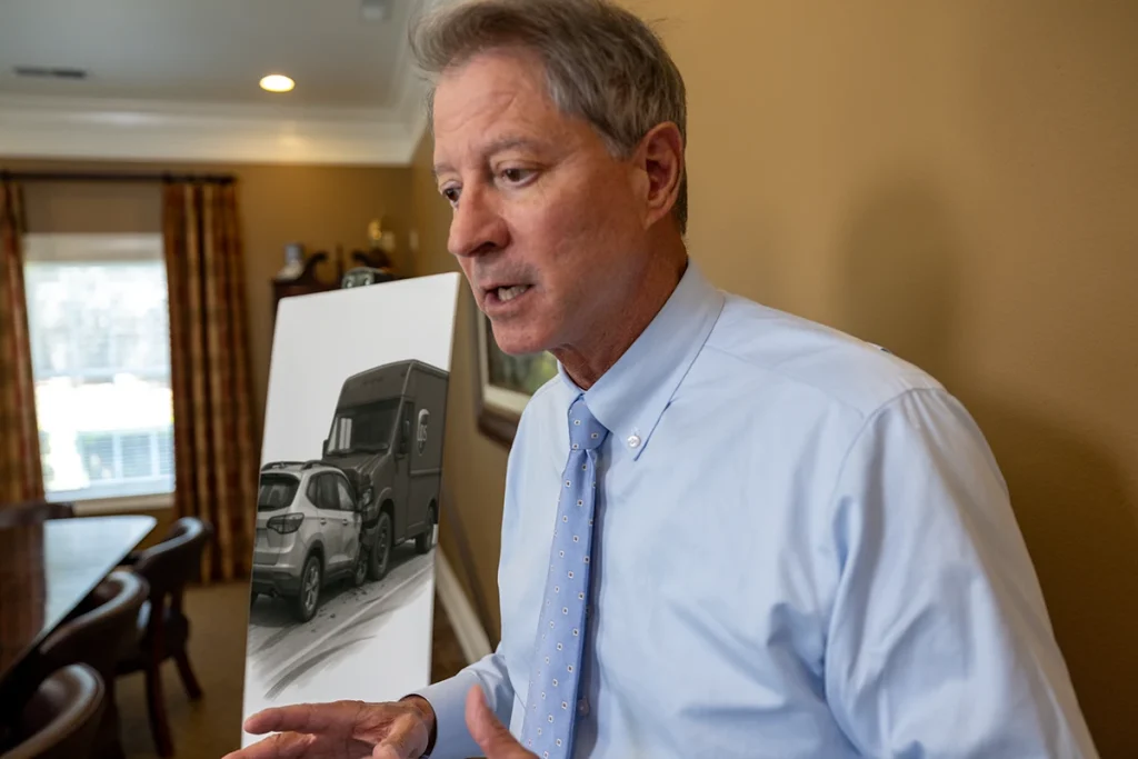 Tom mccutcheon consults with a client about a ups delivery accident case.