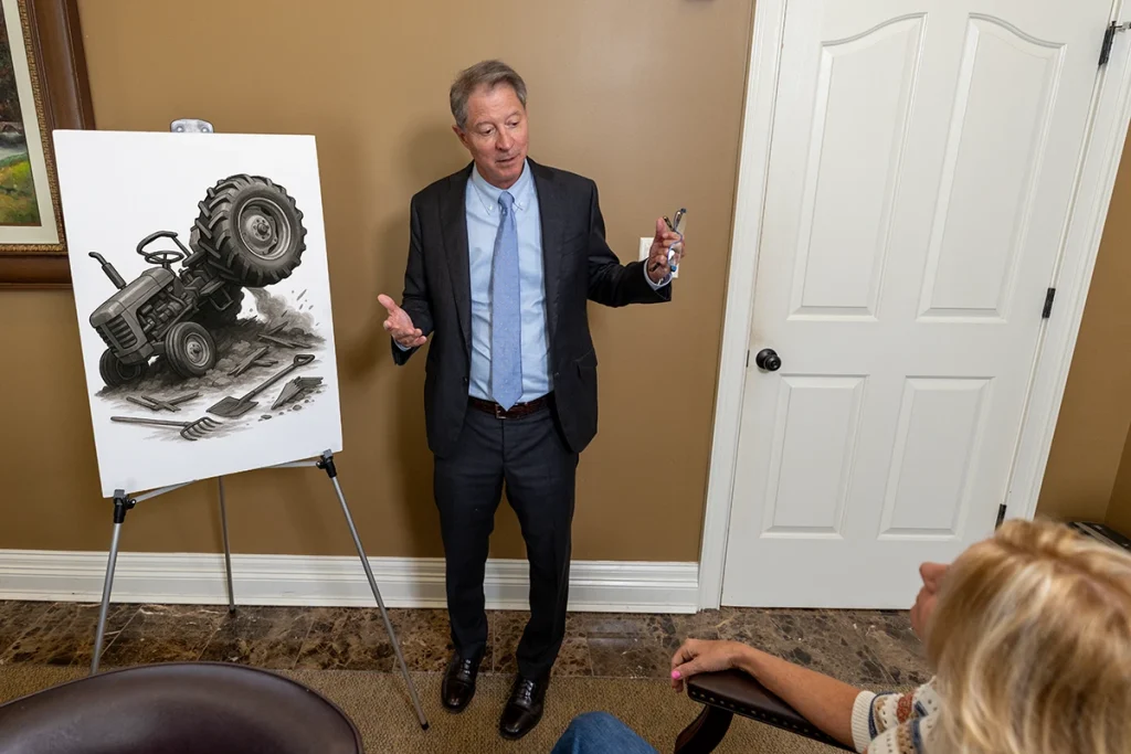 Tom mccutcheon consults with a client about a tractor accident claim.